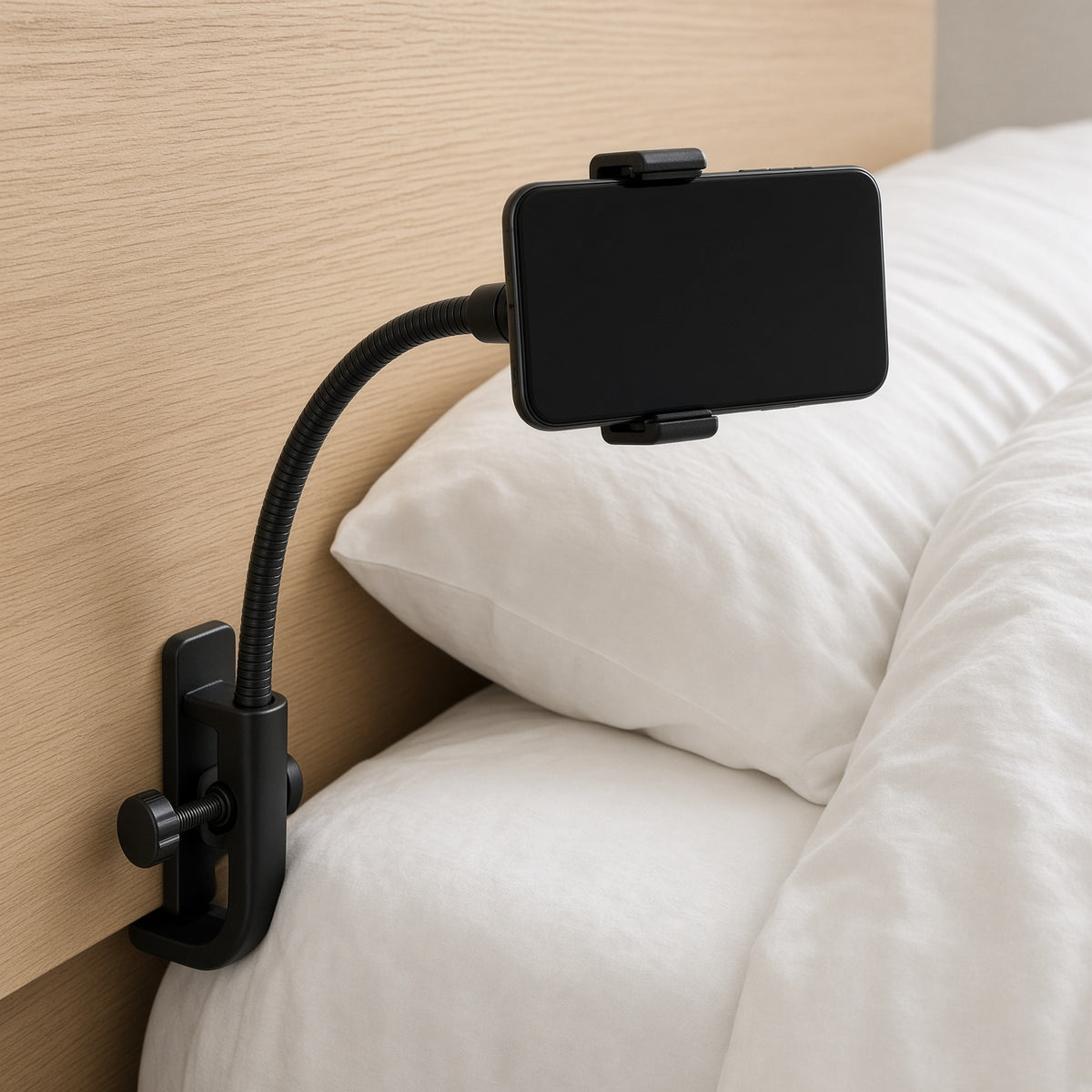 Black gooseneck phone holder clamped to a headboard over a bed